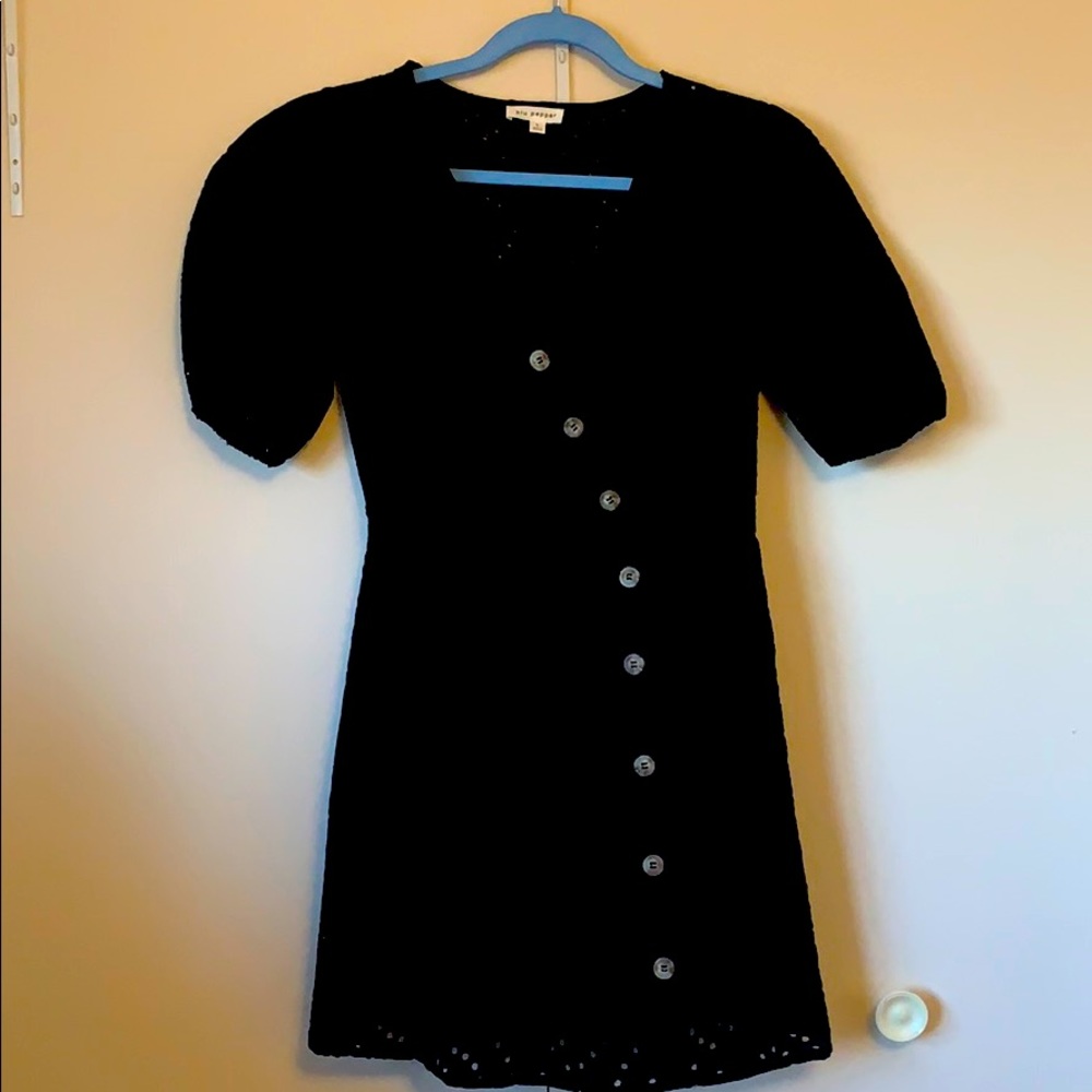 Black short-sleeved crocheted pattern dress.